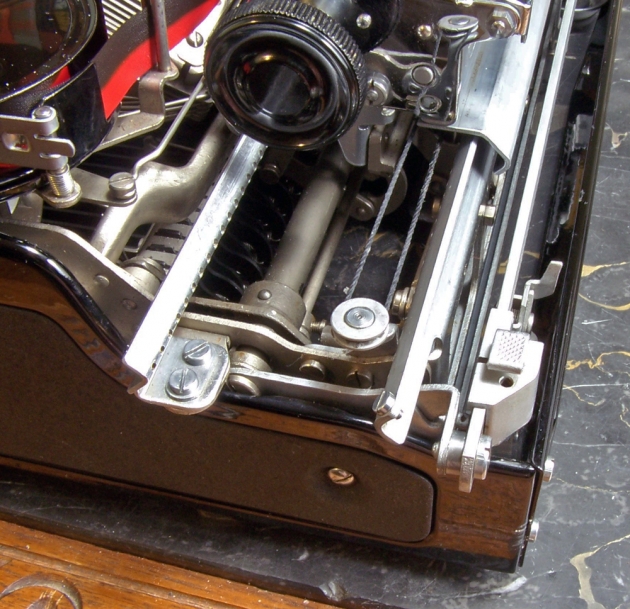 Pulley which allows the mainspring to pull the carriage to the right, for right to left typing.