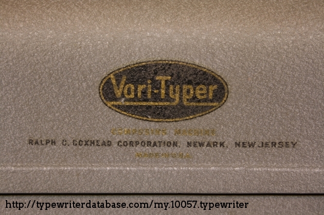 The front logo here is in good condition, although the gold writing is faded and almost completely illegible. It is identical to the label on the back, which seems to identify this as a "Composing Machine".