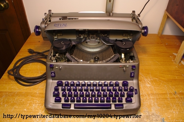 Pressing the lid-release button opens the lid and exposes the ribbon, ribbon-directional switch, typebars, and touch control dial.

There is a safety mechanism that automatically shuts off the typewriter if the lid is opened while it's on.