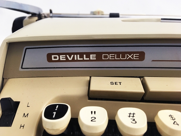 Smith-Corona "Deville Deluxe" model name... (note the added one and exclamation key)