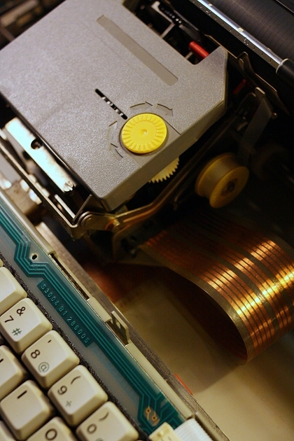 The printer unit with Group 176C (carbon) cartridge (grey). Under the cartridge the small yellow spool of the Group 168 correction tape is visible