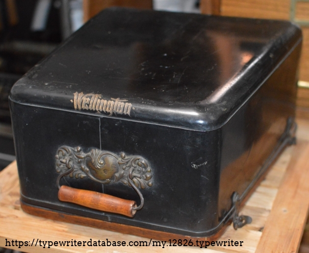 Carrying  case with Wellington decal at front edge and ornate handle  base