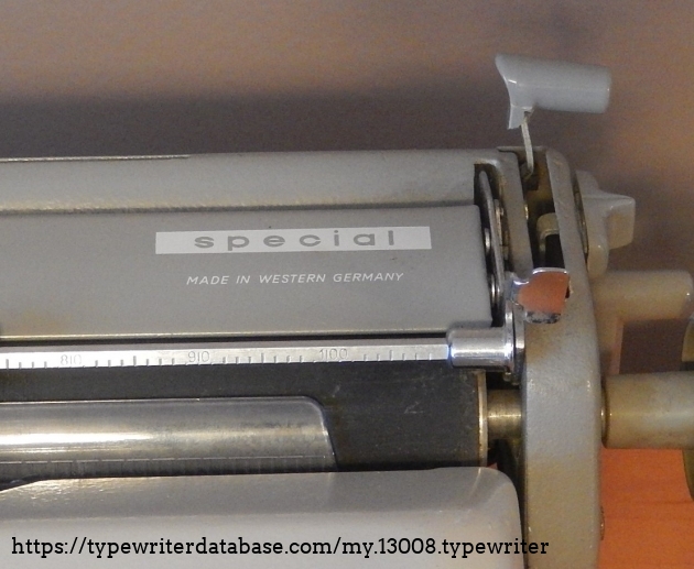 A close up of the model decal on the erasure table as well as the paper release lever, the margin and tab setting lever just below it, and the right carriage release.