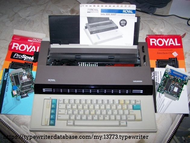 The typewriter with both peripherals (dictionary, parallel card) and manual.