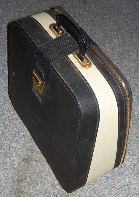 The carrying case, with two flies under the strap. Doesn't have a way to secure the typewriter down inside (and you can't use it inside the case), just foam pads on the latch side of the case for under the machine and a pad at the back of the typwriter (which the machine would rest on when carried/sitting). Do not have the key for the latch.