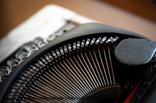 Typebars with pica slugs. Note the plastic spool cover on the right of the picture.