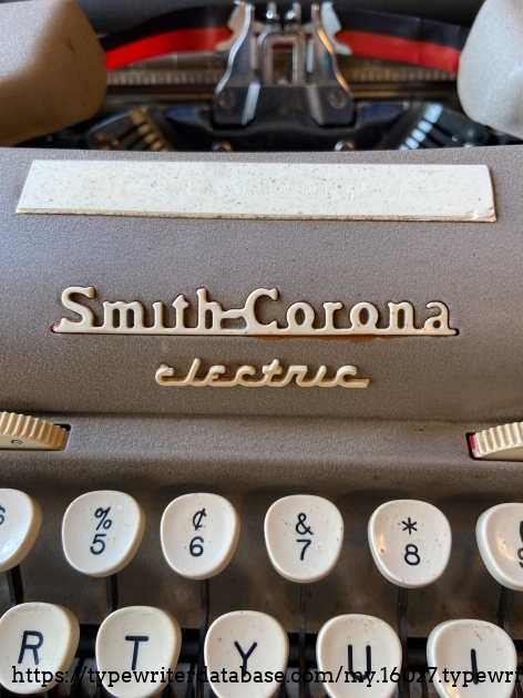 Slightly broken 'Electric' badge. On some of these this is red. The big white thing is an old owner's name label.