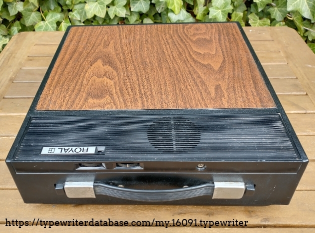 Carrying case of the Royal 260.. Radio adjustment knobs can be seen on the front, radio speaker on the top.