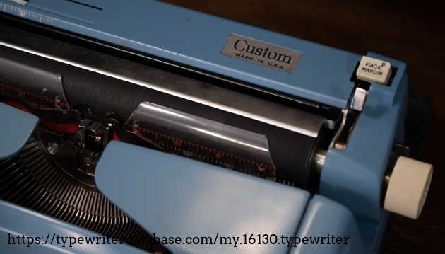 "Custom" nameplate. Also a good view of Royal's "Magic Meter" card guides, which are used instead of a paper bail on this machine. "Custom" nameplate. Also a good view of Royal's "Magic Meter" card guides, which are used instead of a paper bail on this machine.