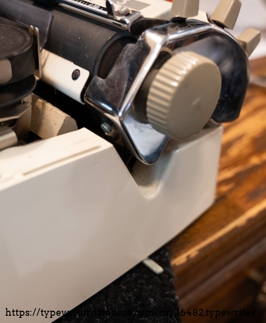 That little metal lever sticking out from underneath the typewriter is the carriage lock switch.
