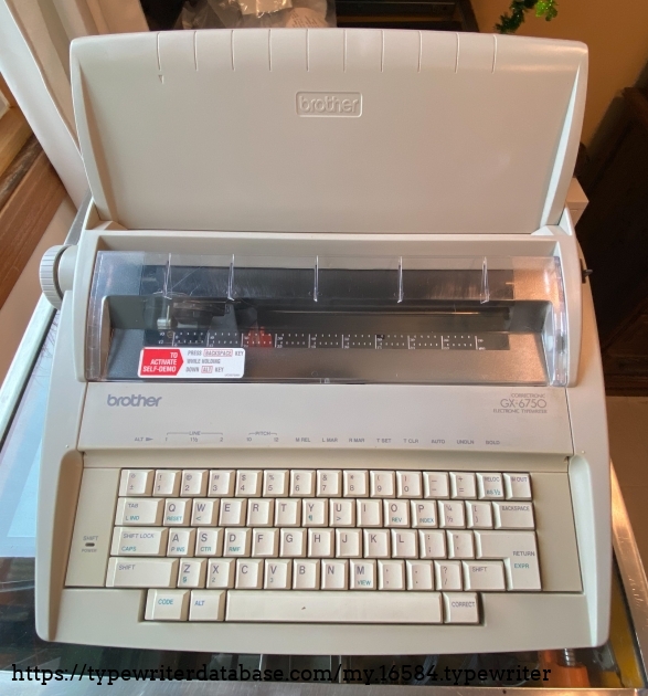 Keyboard cover in place as paper rest. Notice the yellowed plastic around the keyboard.