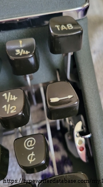 Right keys close-up, including fraction keys, back-space arrow, ribbon selector lever, and tab.