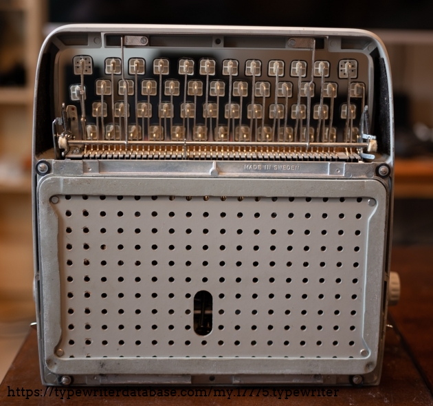 Pegboard underside! The entire edge of the pegboard-looking surface is the typewriter's foot.