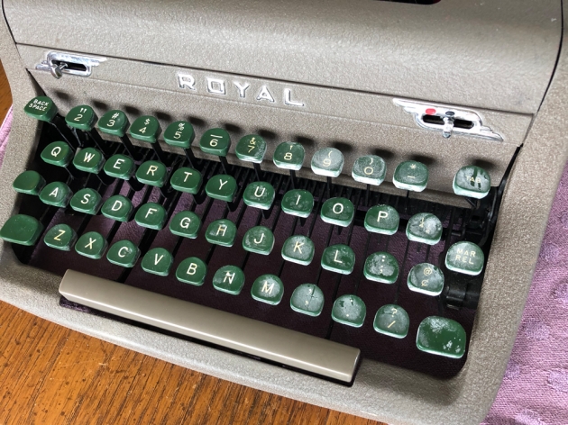 Keyboard half cleaned---right side untouched, left side after about five minutes swabbing with Goo-Gone, which is marketed as an adhesive-residue-remover.