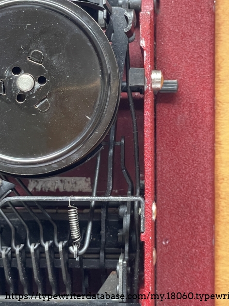 The number 24715 is stamped on the bottom of the machine, just below the right ribbon spool. Several entries in the Typewriter Database use a number from this location as the serial number.