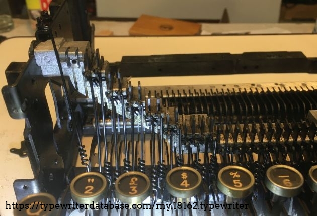 pull rods that connect the key-levers (below)  to the linkages that pull the type-bars.