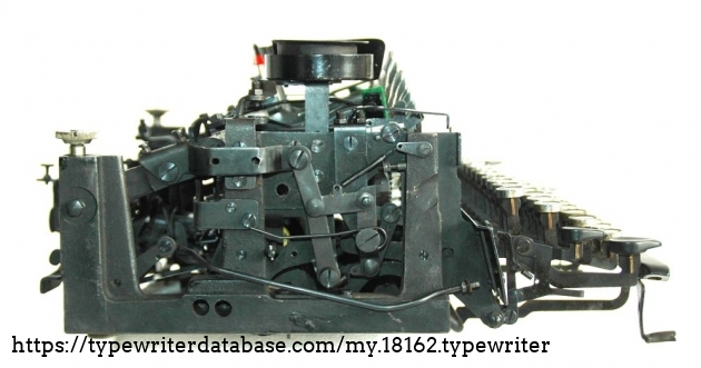 the cast iron frame with the articulated arm that locks the typearm-basket in its upward position, unless the uppercase key is pressed. A brilliant feature of this machine, but hard to explain.