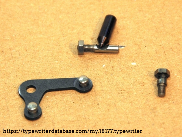 the the right: an excenter-bolt
the middle part-set serves to adjust and secure the pointed spindle.