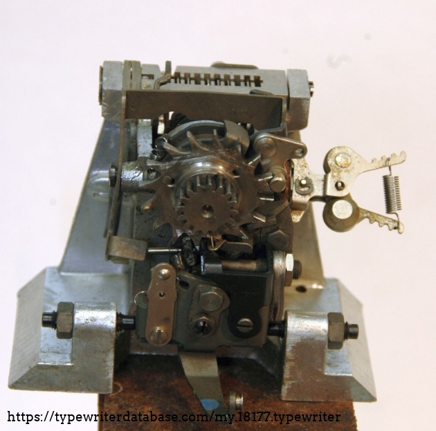 escapement module on wooden pedestal.