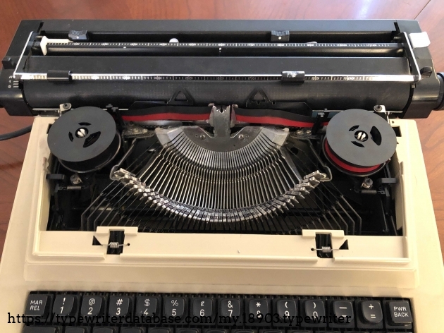 View of type bars with front cover removed. Note dual color ribbon replaced original correctable ribbon that had both black ink and white correcting tape. The white part of the ribbon made a huge mess inside of the typewriter.