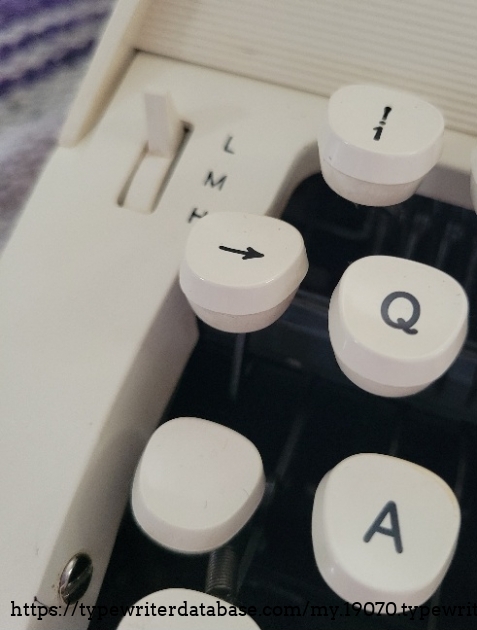 Close-up of left keys, one/exclamation mark, backspace, touch selector.