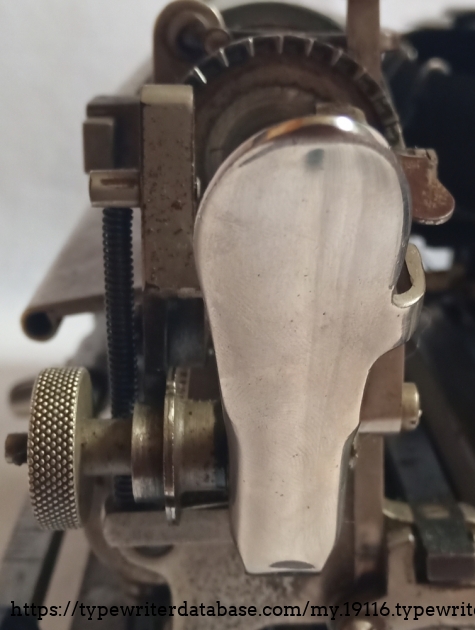 This is the carriage return mechanism with the carriage switch lever and the roller gear. from the front