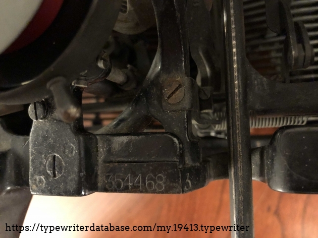 Serial Number, located on the right side of the machine under the carriage (see ribbon in top left corner of picture). Unsure if the number 3 on the right side is part of the serial number.