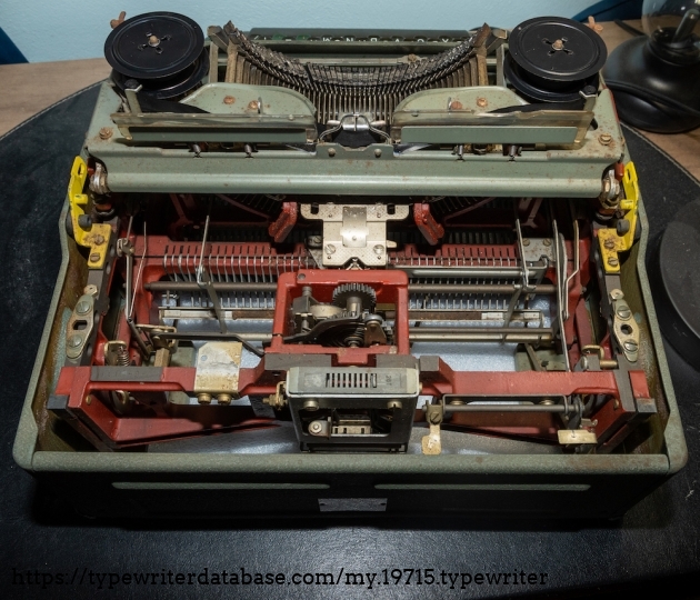 Back of the typewriter with the carriage and ribbon cover removed. Note the fairly substantial red painted cast iron frame.