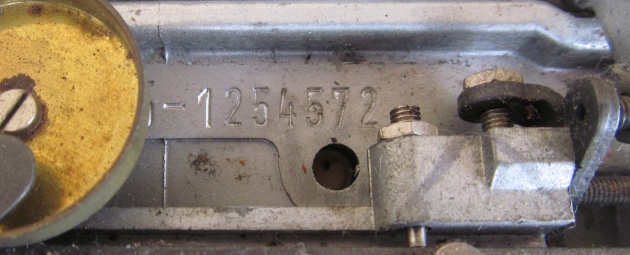 Move the carriage all the way to the left to find the serial number (partially obscured by the bell).