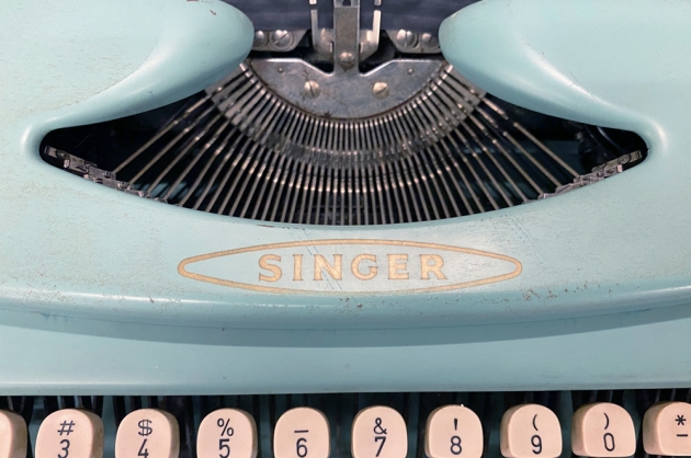 Singer "Scholastic T2" from the maker logo on the top...