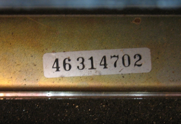 The serial number is on a sticker under the carriage, and with the machine off you can see it even without lifting the lid.