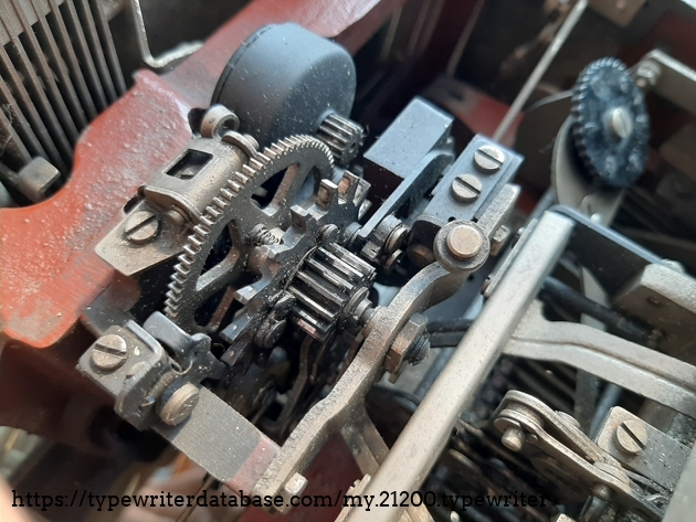 The escapement mechanism. Keys tension regulator on the right.