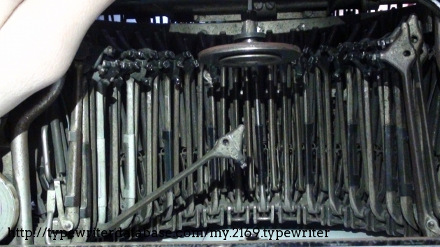 Here is the normal typebar on the machine. You can also see the disk near the top that allows some keys to shift.