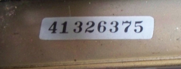 The serial number is on a sticker under the printhead.