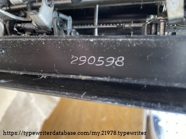 Close up view of inscribed serial number on bottom of machine.