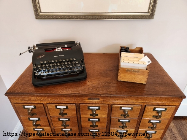 Close up of Gaylord Bros. library card catalog with a smaller desktop card index and black Smith-Corona Clipper typewriter on top
