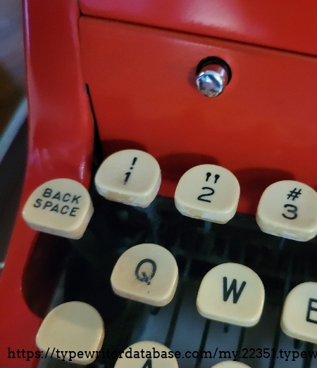 Close-up of left keys and cover open button.