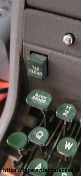 Left side, tab clear, cover-opening button.