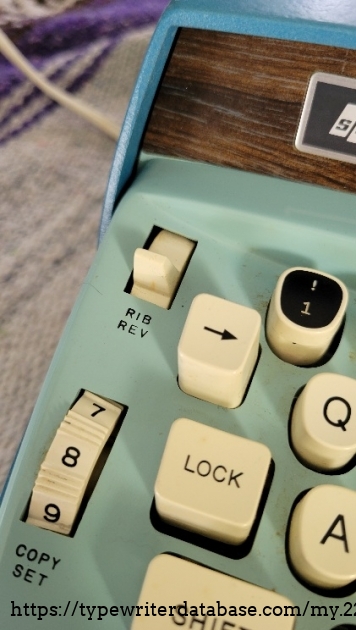 Left keys close-up - ribbon reverse, copy set, backspace, black customizable key 1/!.