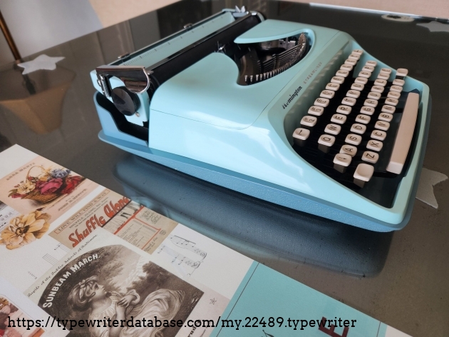 Left side of the Remington Streamliner typewriter featuring a lovely mint blue luster and a a shiny chrome carriage return.