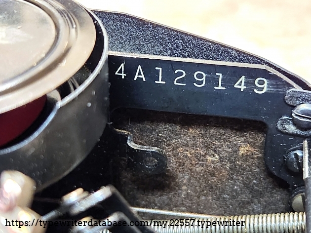 Serial number located beneath the ribbon cover and visible on the right hand side in front of the ribbon spool.