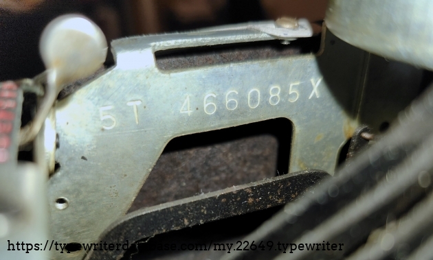 Serial number 5T 466085X. Located below the ribbon cover, by the left-hand ribbon spool.