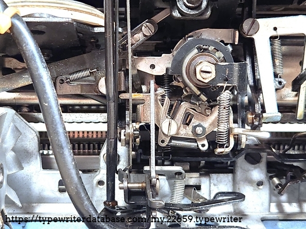 A closeup of the escapement, the carriage brake (the curving spring in the middle--you can see the star wheel behind it), and the spring barrel at the top left.
