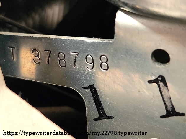 Serial number 6T 378798. Unusually hard to see. Hidden by the ribbon cover on the right side.