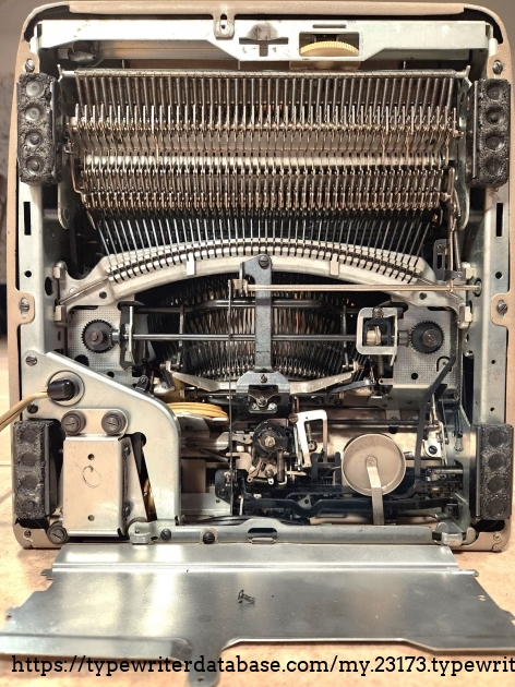 An overview of the underside. Note the cover plate that is usually covering the cam and lever system at the top of the image since it is critical to the operation that it remain undamaged and unencumbered by stray items on the desk, etc.