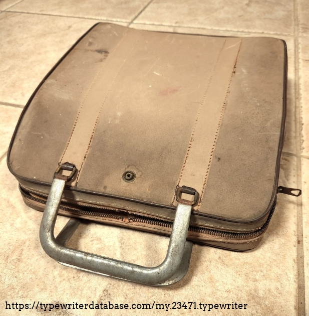 The case is much the worse for wear, discolored, and covered in grime. The accent stripes are gone, the leather covers on the handles are gone, and the strap meant to cover the zipper draws is also torn away. It is still sufficient for storage and gentle transport but requires delicate treatment.