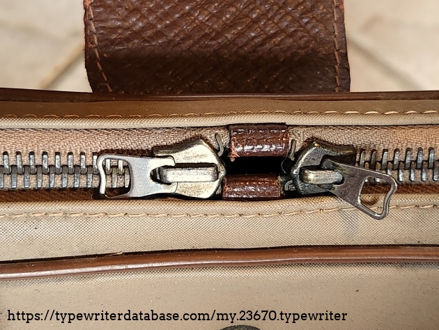 Notice the leather stops between the two zipper draws. When closed, they are exactly up front.