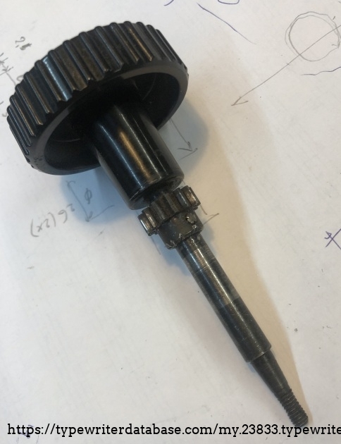 Right hand platen knob assembly with taper and thread. The paper injector engages pinion wheel