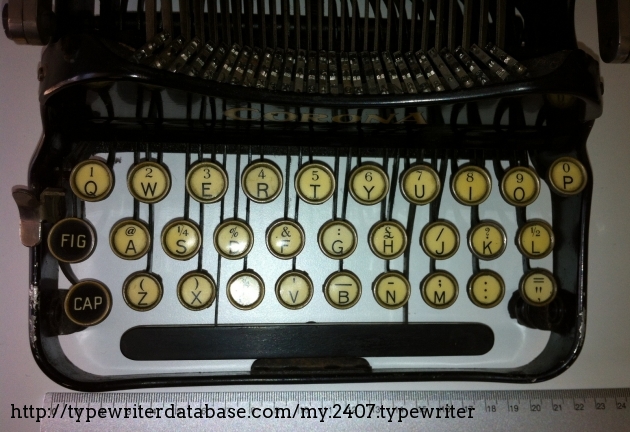 The three-row keyboard helps reducing the overall measures, though required some training when the typist was used to a standard 4-bank typewriter.
That lever on the left is used to hold the platen when you fold the typewriter.