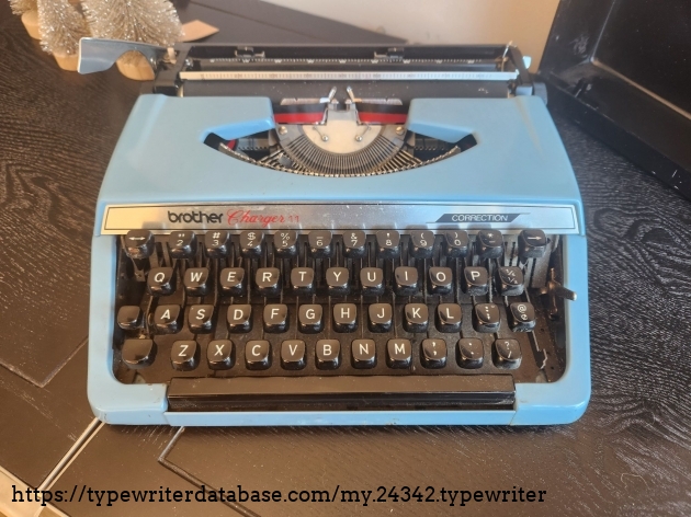 Front view down onto a Brother Charger 11 featuring a keyboard with white letters on black plastic keys.